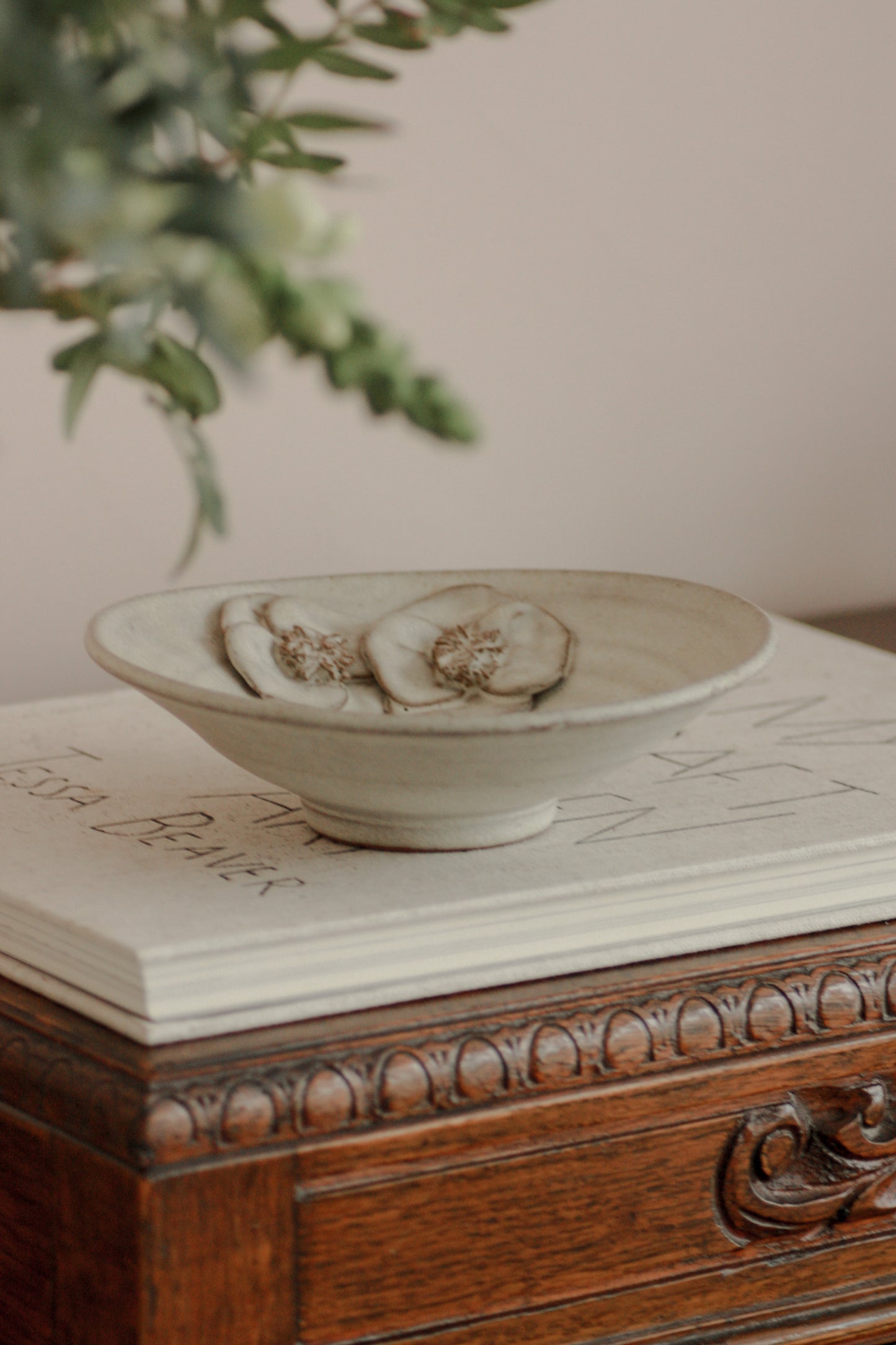 Rustic studio pottery bowl with rustic glaze and floral details