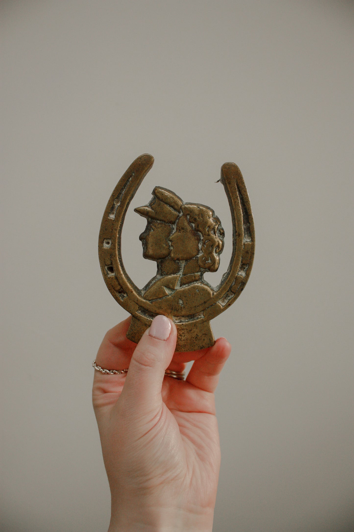 Vintage brass trivet with couple design