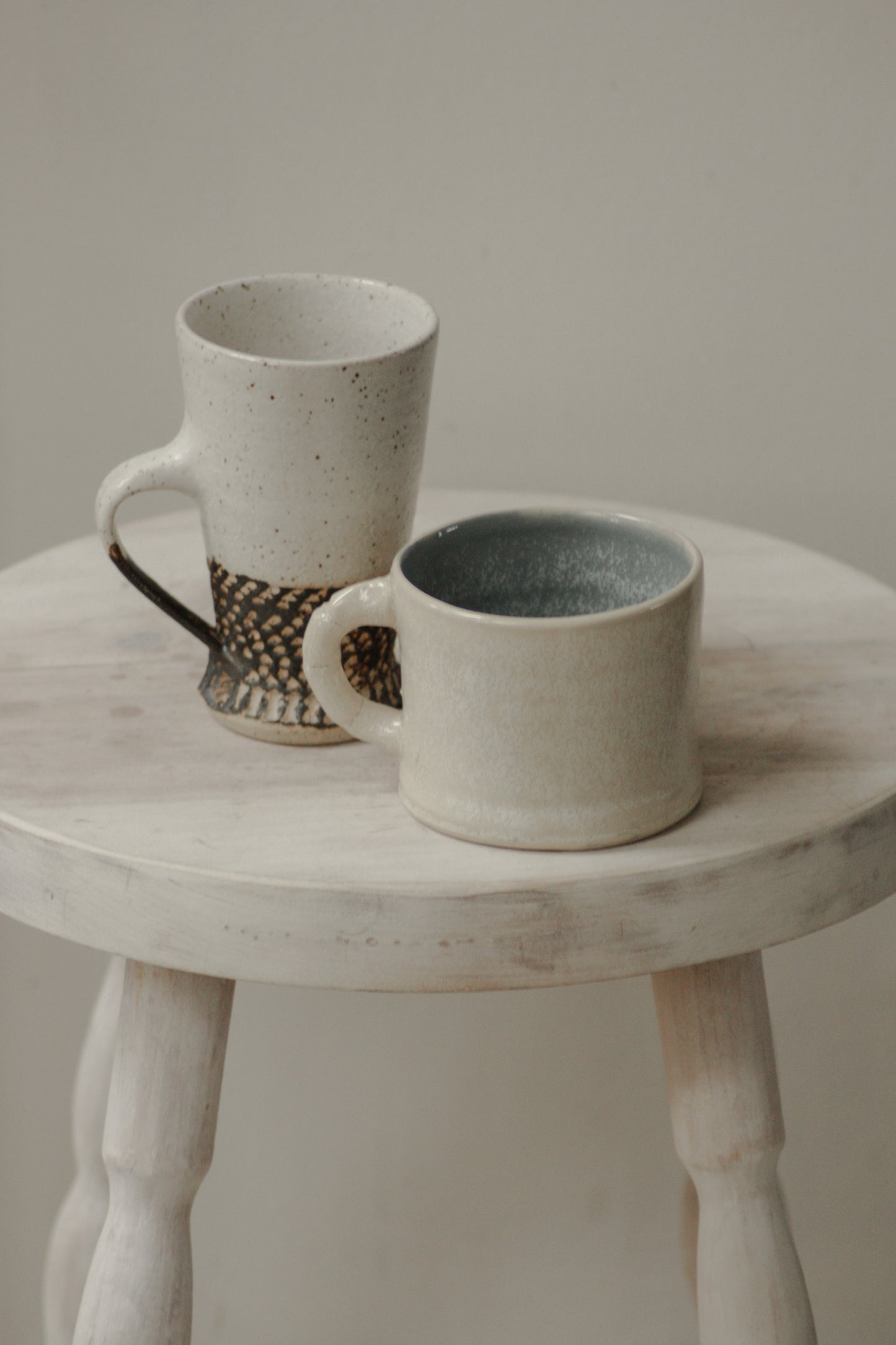 Studio pottery mug with rustic off-white glaze