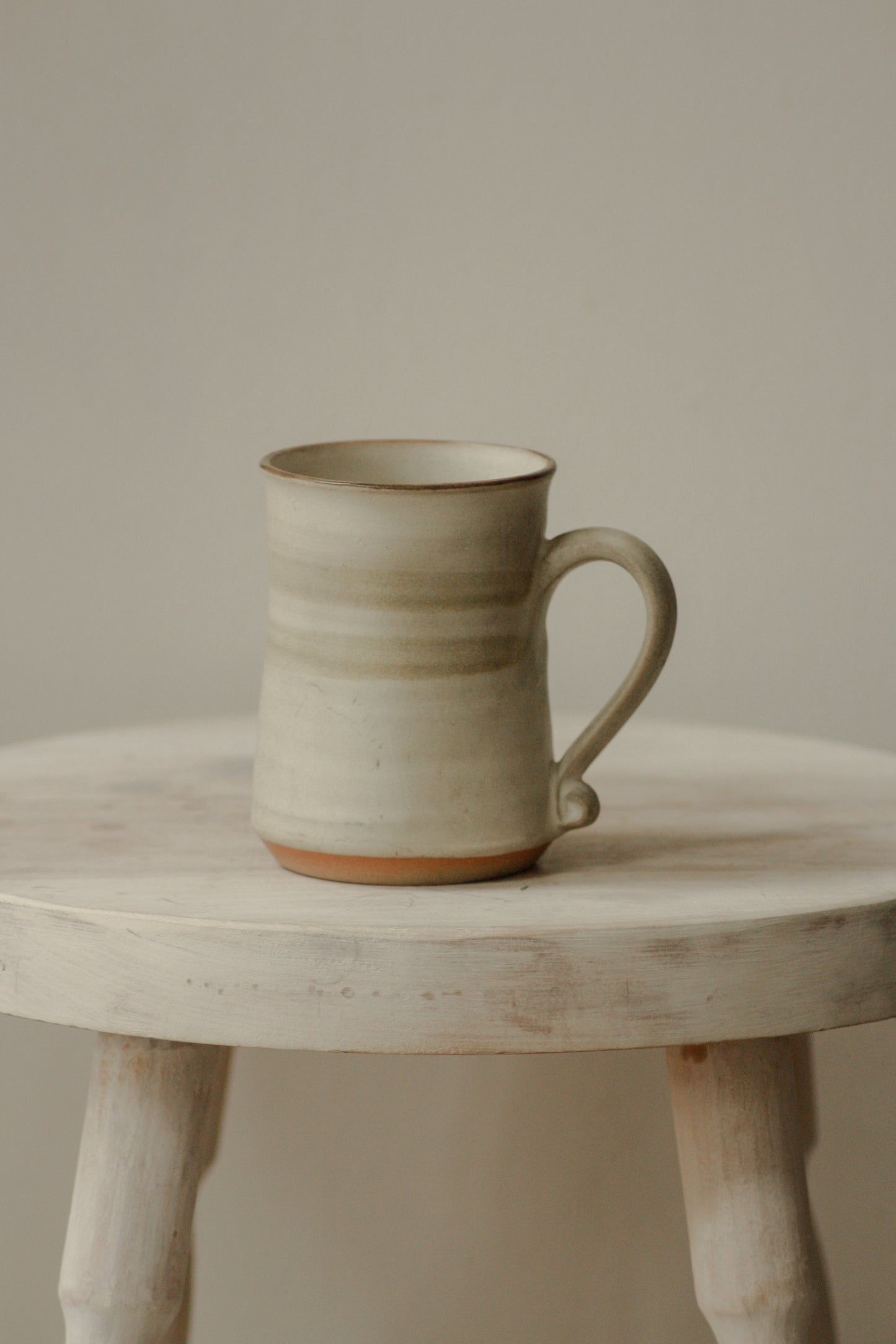 Vintage studio pottery mug with muted green stripe