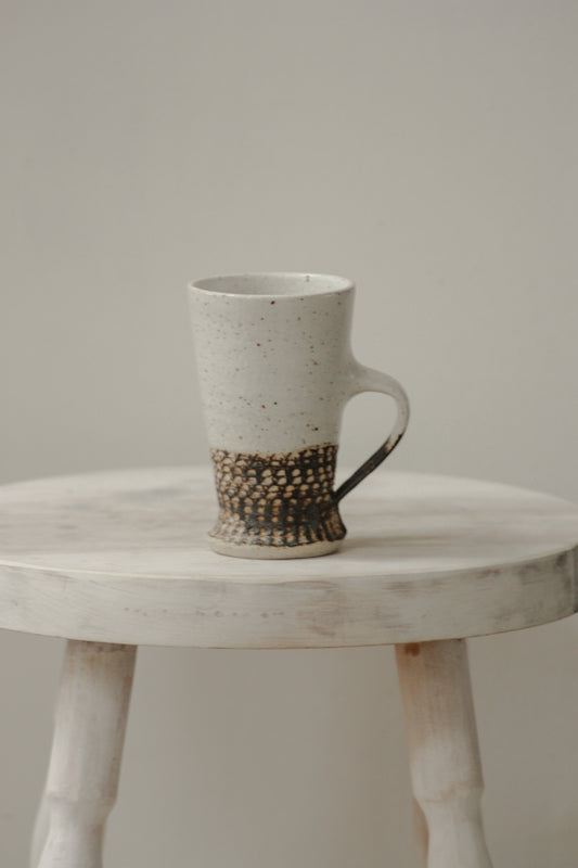 Studio pottery mug with rustic off-white glaze