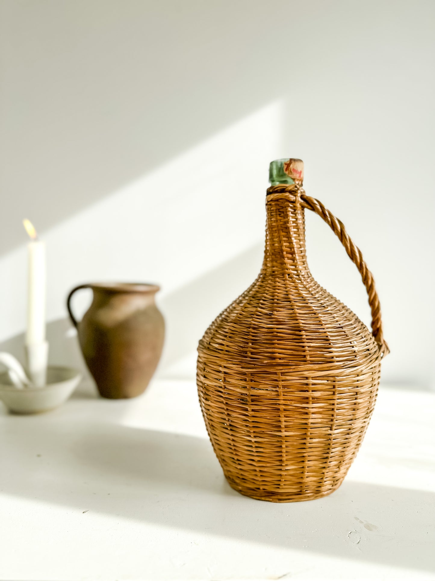 Vintage French wine bottle in woven case