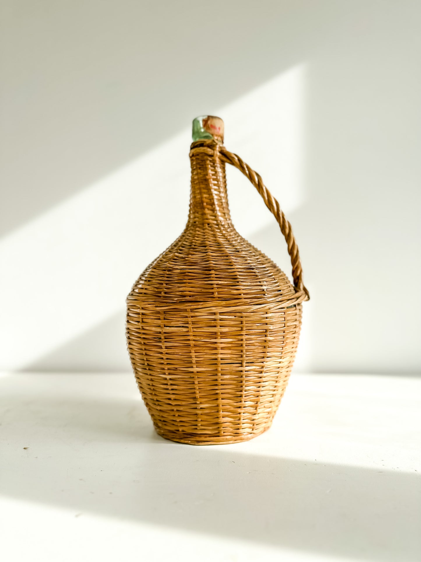 Vintage French wine bottle in woven case