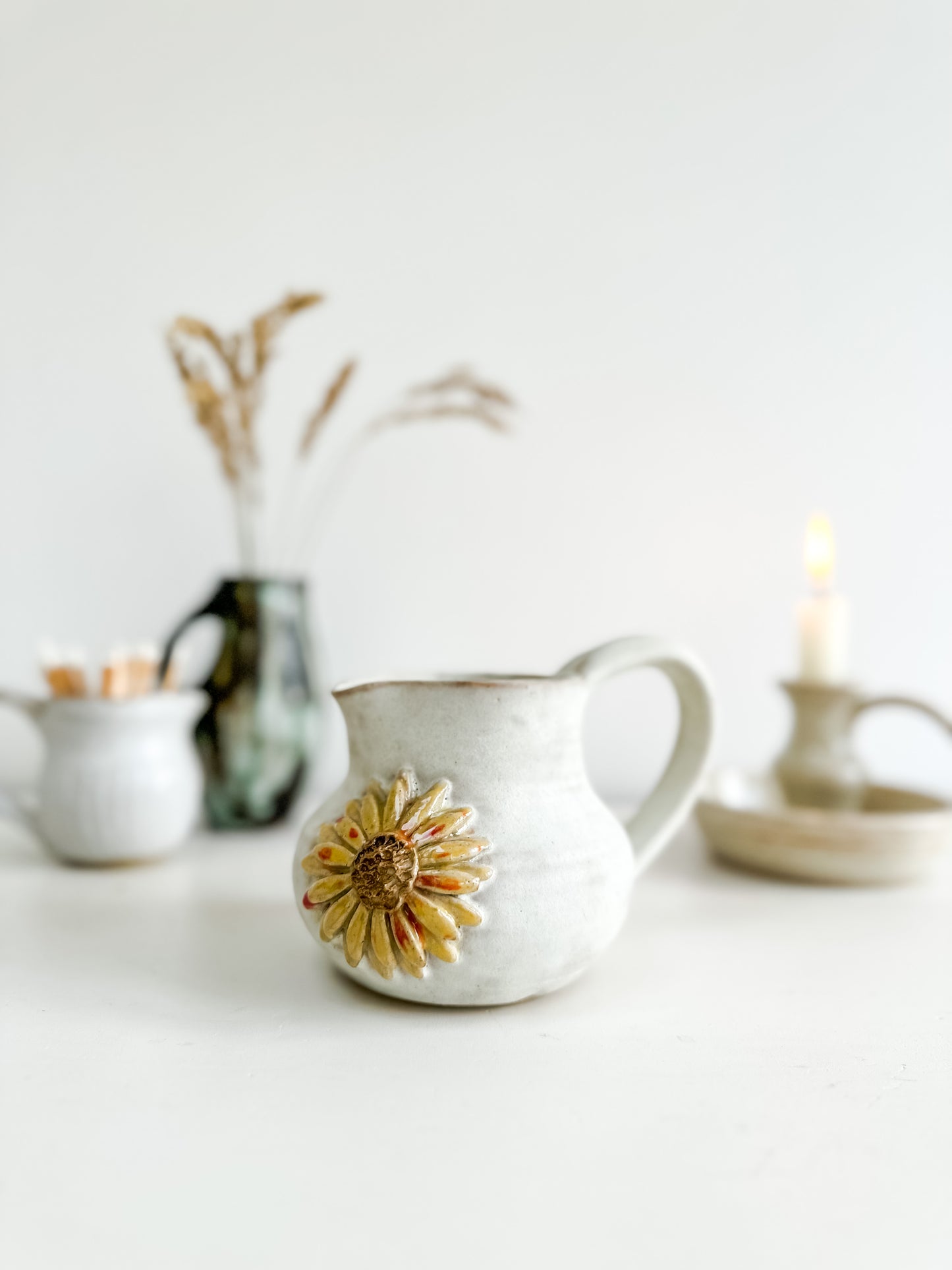 Studio pottery creamer with sunflower