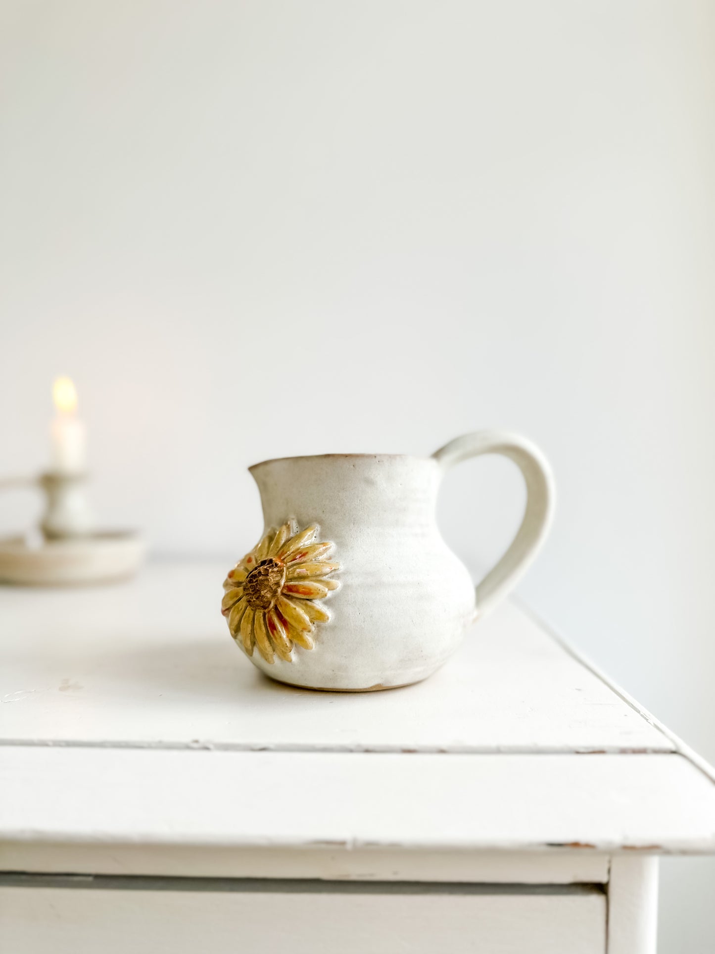 Studio pottery creamer with sunflower