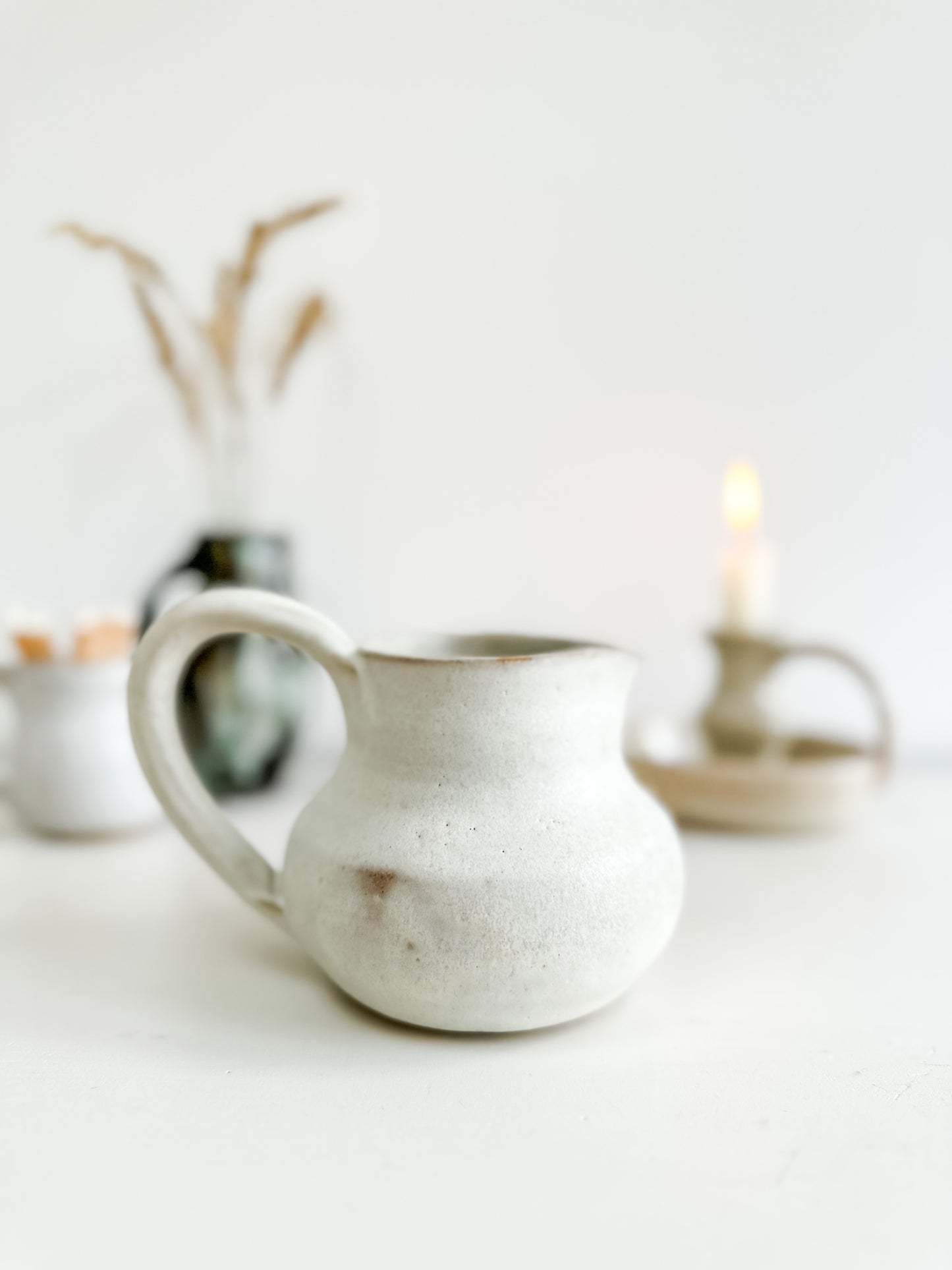 Studio pottery creamer with sunflower