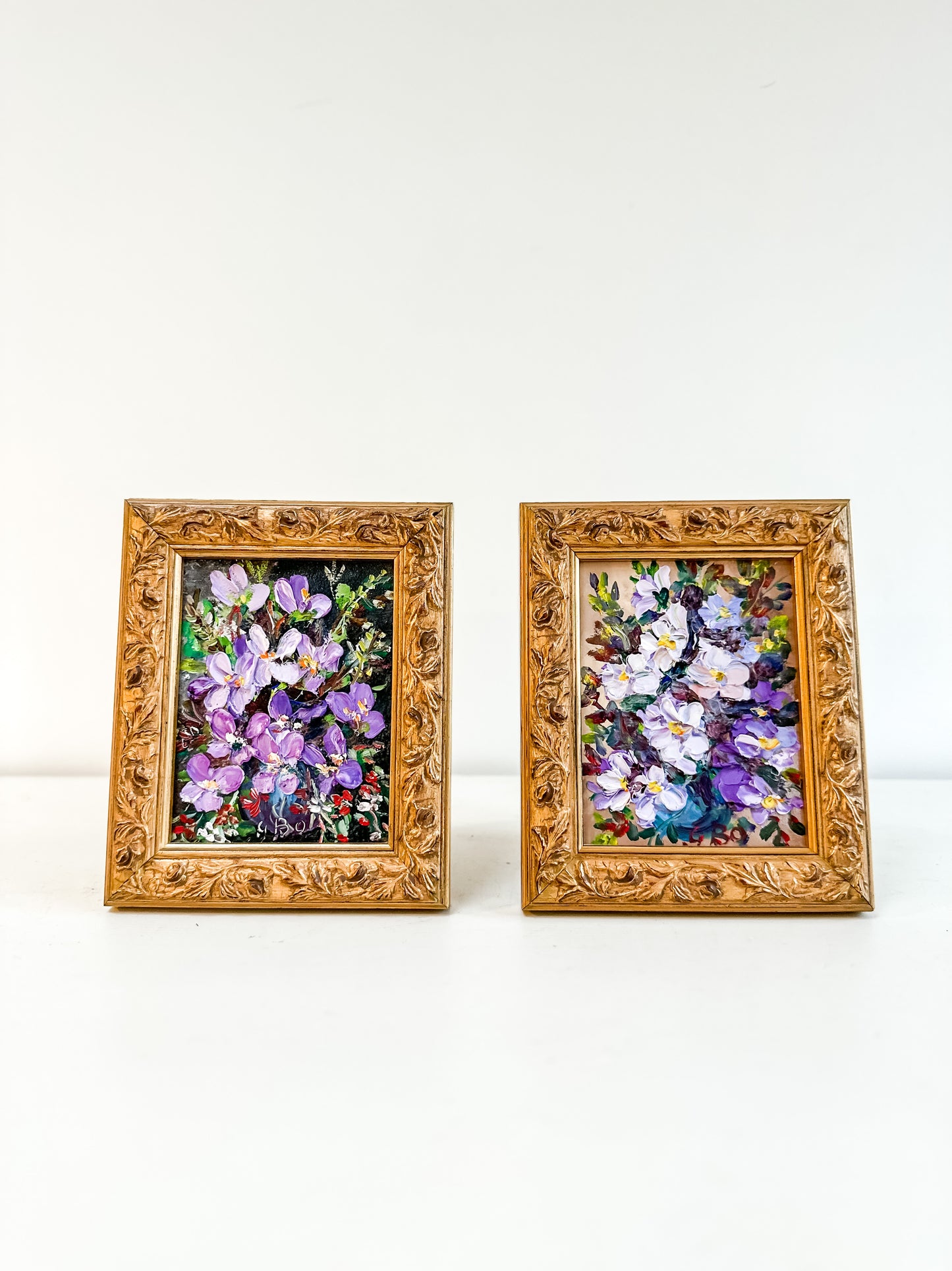 Pair framed vintage floral paintings