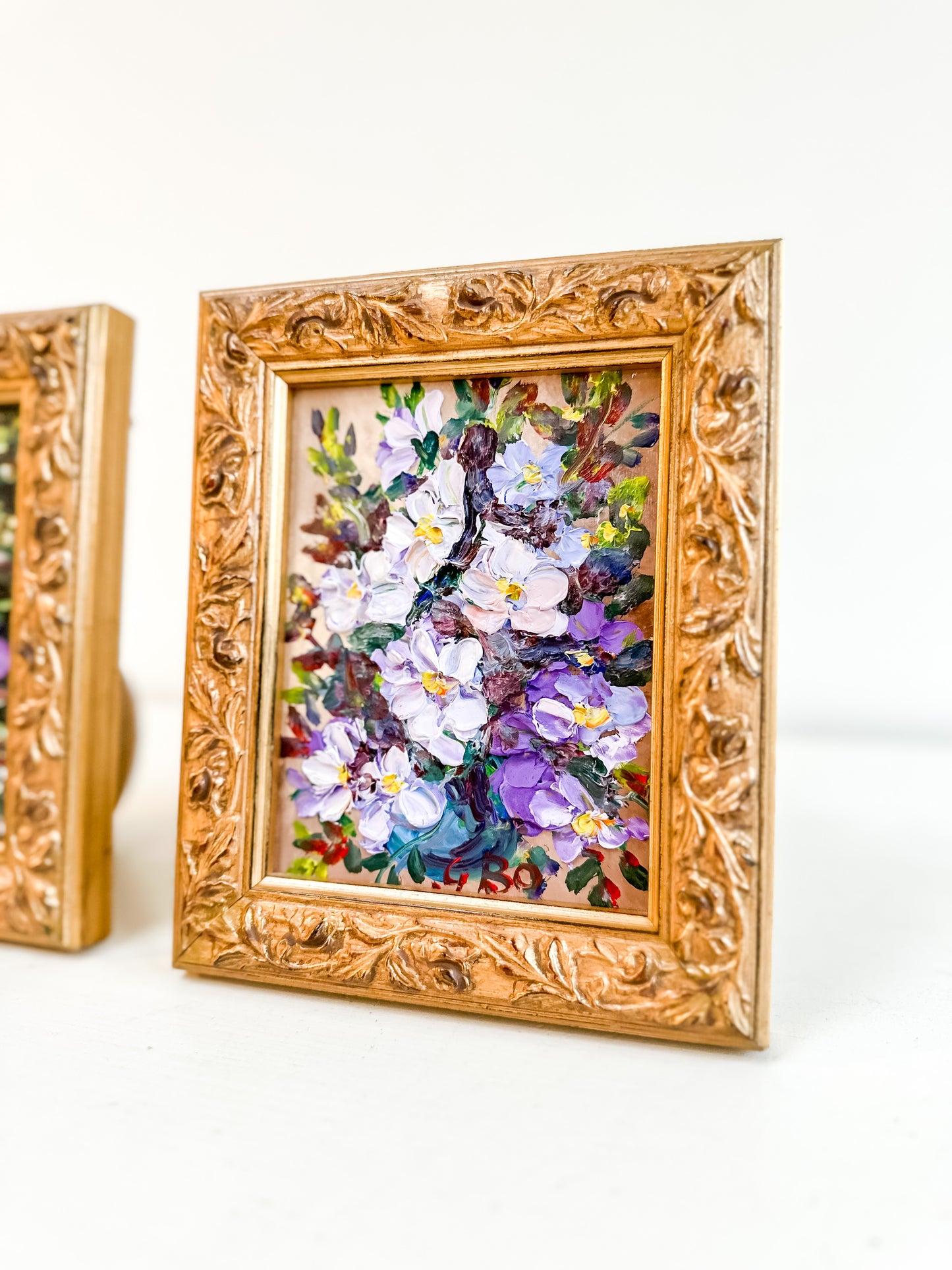 Pair framed vintage floral paintings