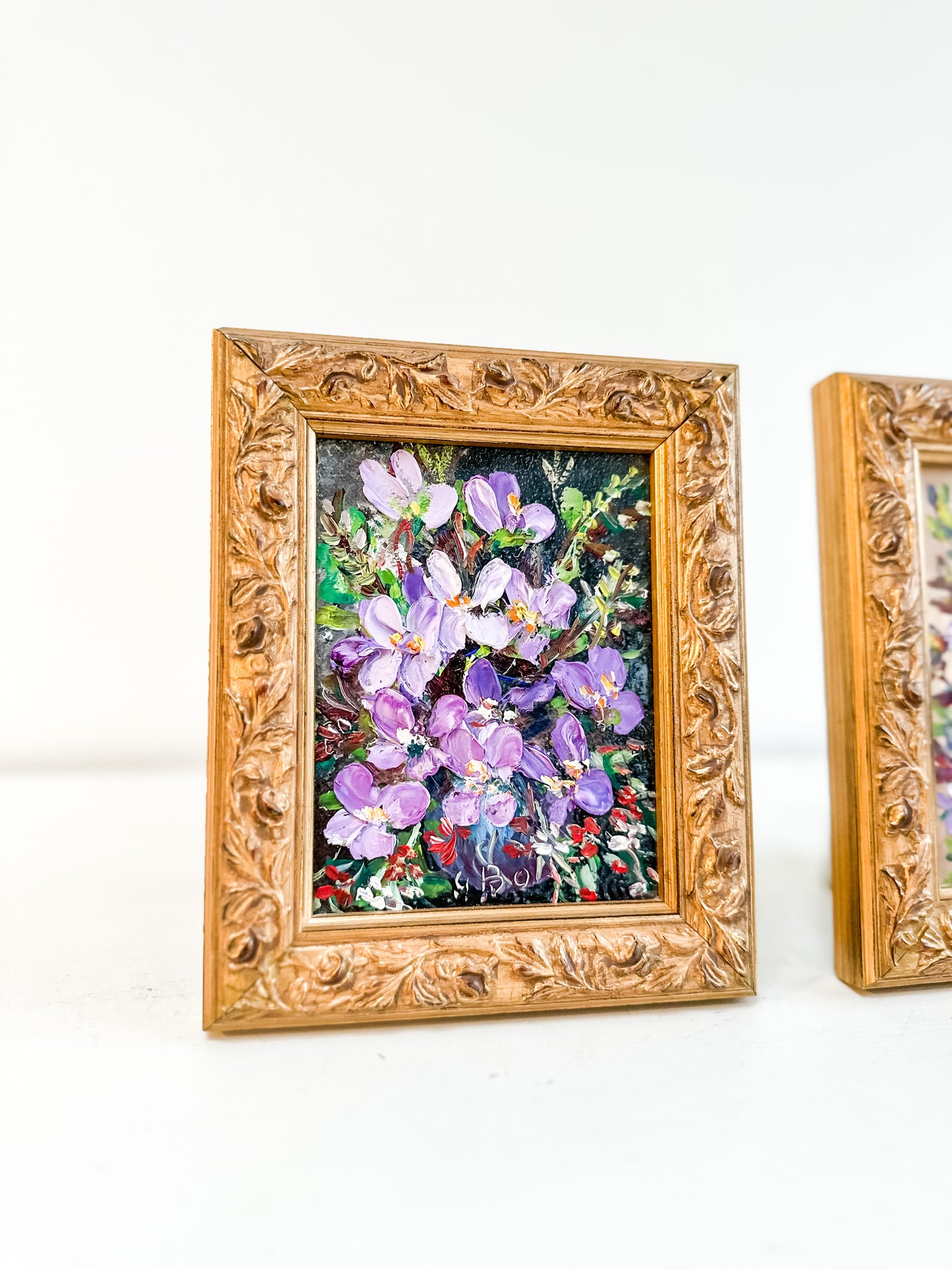 Pair framed vintage floral paintings